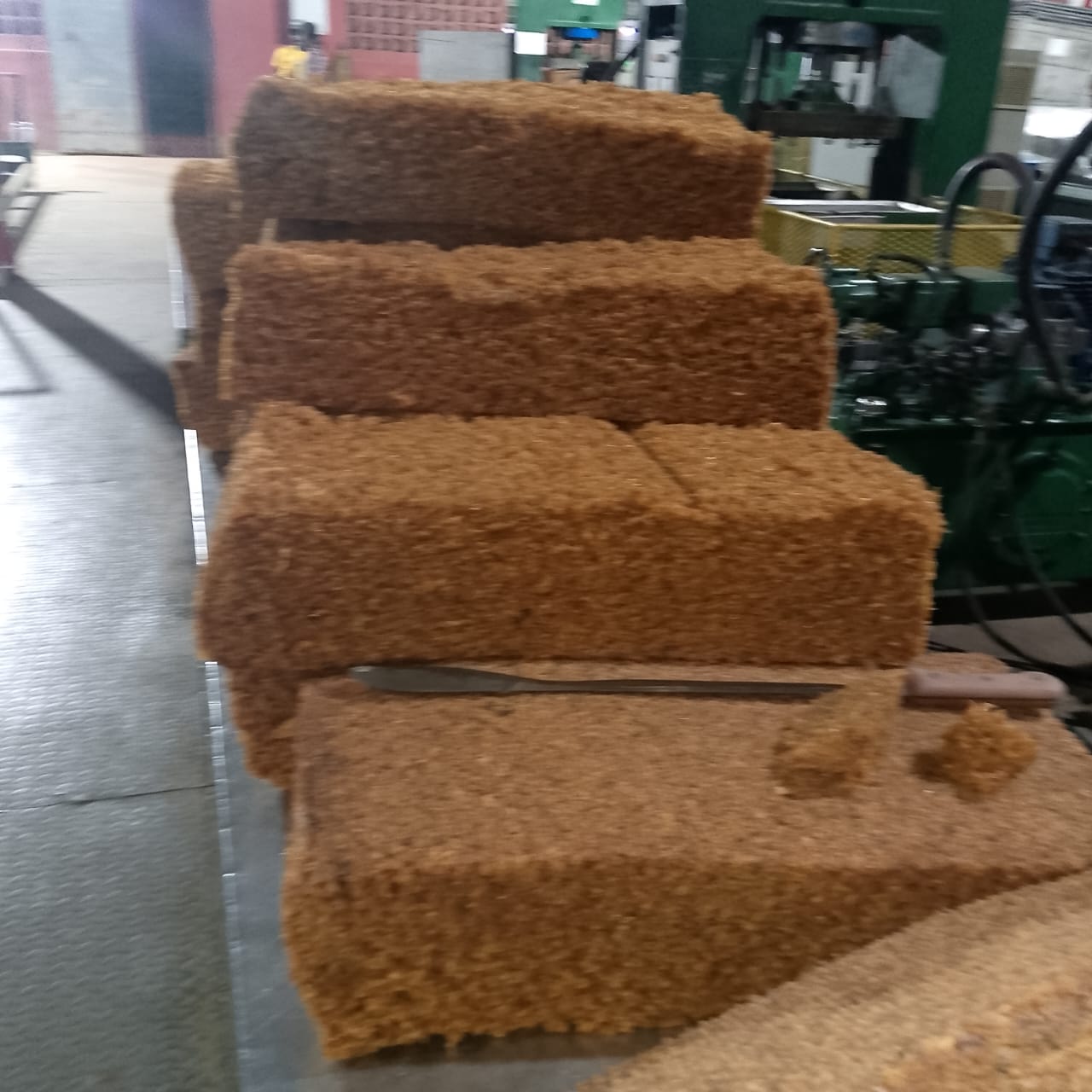 Blocs de caoutchouc naturel pressés sortant de la presse